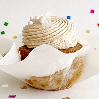 Vegan cinnamon cupcake topped with vegan cinnamon brown sugar icing.