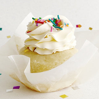 Vanilla cupcake with vanilla swiss meringue buttercream and colourful sprinkles. 