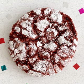 Vegan red velvet crinkle cookie rolled in icing sugar. 