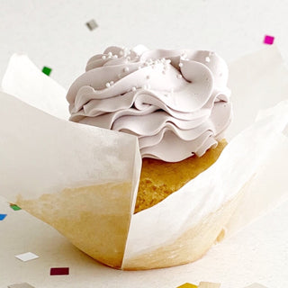 Earl grey tea cupcake with a light lavender lemon swiss meringue buttercream and small white round sprinkles.